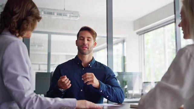 Business meeting of busy entrepreneur people sitting at table, talking, discussing financial trade strategy or project idea. Young real estate manager worker man talking with bank client in office