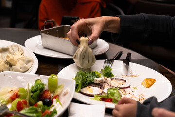 A joyful family enjoys a gourmet dinner, sharing delicious dishes that showcase wealth and fine dining. Laughter fills the air in a welcoming, elegant atmosphere.