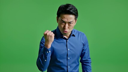 Energetic male presenter points toward camera against green screen.