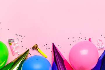 Composition with balloons, party hats, confetti and party horns on pink background