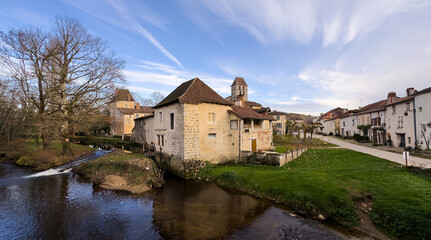 Fototapeta premium Picture of a beautiful river lined with stone houses in south of France. Countryside vacation background.