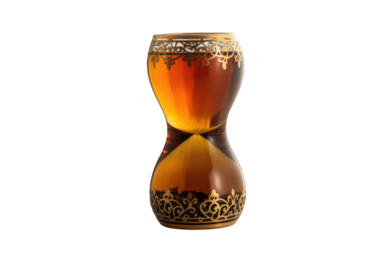 An ornate hourglass-shaped glass with amber liquid and gold filigree patterns, possibly for tea, isolated on a dark transparent background. background removed