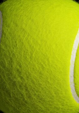 Extreme close-up of bright chartreuse tennis ball felt texture. Seamless fibrous material background, perfect for patterns ,cover ,fabric ,fluffy
