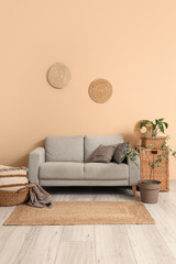 Interior of stylish living room with cozy sofa, carpet and houseplants