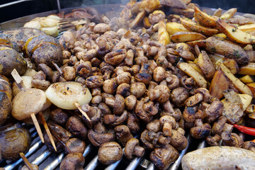 Fried champignon mushrooms and potatoes. Various hot foods