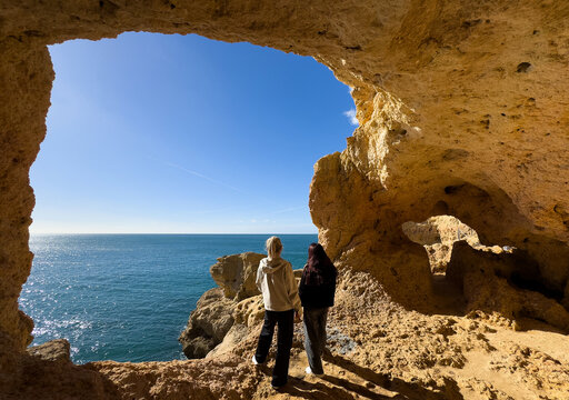  Cave along the Algarve coast in Portugal. Blue sky seen from inside the cave on the cave tour boat.