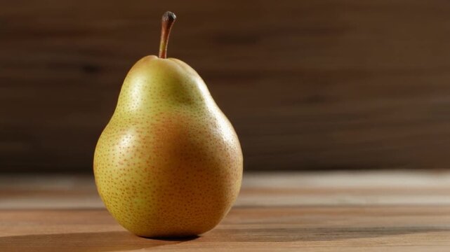 Ripe pear gently rotating, capturing its smooth skin and subtle color variations, perfect for food blogs or health-focused recipe videos (148)