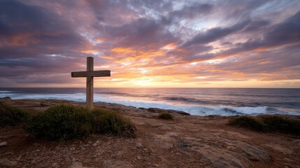 A simple cross in a windswept coastal landscape, with waves crashing under a fiery sunset. 