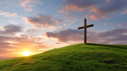 A simple wooden cross stands atop a grassy hill, silhouetted against a vibrant sunrise. 