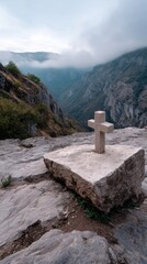 A small cross carved into a rocky cliff, surrounded by misty mountains at dawn. 