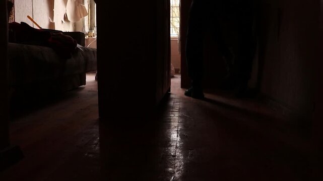 People clean up after a drone exploded near a multi-story building, causing a blast wave that blew out a window and damaged an apartment in Ukraine