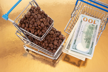 Coffee beans overflow a shopping cart alongside $100 bills on a reflective gold surface, ideal for themes of money, trade, and gourmet products