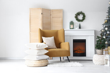 Fototapeta premium Interior of modern living room with fireplace decorated for Christmas