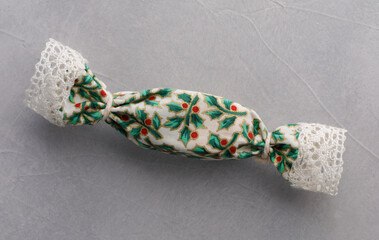 Christmas candy in fabric wrapping with lace