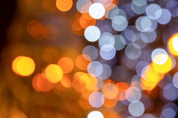 Vibrant golden and multicolored light bokeh on a dark canvas, perfect for festive, artistic, or romantic themes with a dreamy effect.