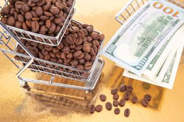 small shopping cart filled with roasted coffee beans sits on a golden surface, accompanied by $100 bills, symbolizing the value of coffee. Perfect for commerce and finance themes