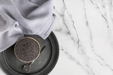 Bowl and spoon with chia seeds on white background