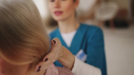 Female caregiver combing hair of senior woman, professional home care service - Powered by Adobe