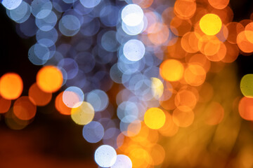 Vibrant golden and multicolored light bokeh on a dark canvas, perfect for festive, artistic, or romantic themes with a dreamy effect.