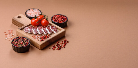 Dry Spanish salami sausage fuet as a snack for the dinner table. Fuet sausage