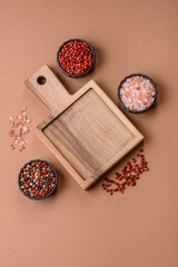 Wood, a wooden empty cutting board on a dark kitchen table. Wooden cutting board