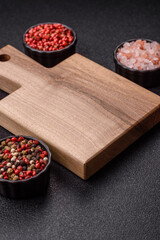 Wood, a wooden empty cutting board on a dark kitchen table. Wooden cutting board