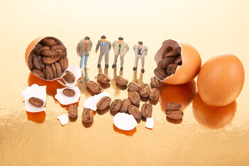 Miniature figures in business and casual attire gather around cracked orange eggs spilling coffee beans on a golden surface, blending surrealism with coffee culture.