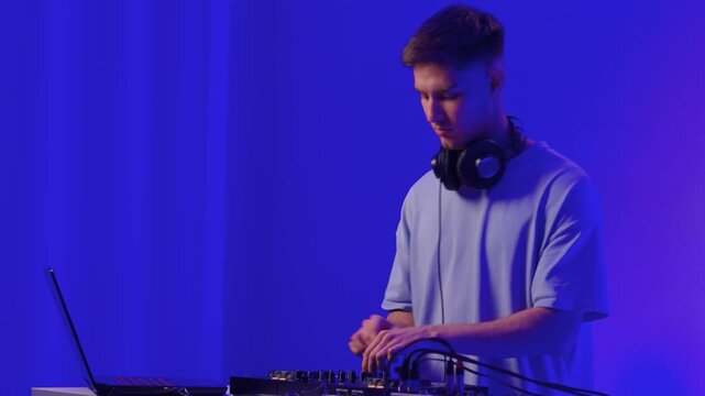 DJ setup overview, Energetic club DJ performing with digital controller in action, Content creator mixing music live using digital turntables under vibrant stage lights