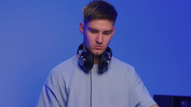 Youthful technician editing sound, Youthful sound engineer meticulously adjusting mixing console within modern streaming design setting to create perfect audio balance