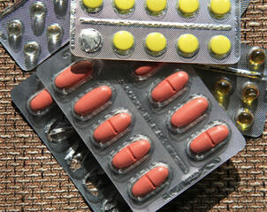 Pharmacy products. A lot of tablets on the fibrous surface. Colorful tablets in plastic blisters. Medicines in pharmaceutical packaging. Colorful tablets in plastic blisters. Medicine and health care