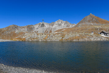 high mountain lake in September with mountains and blue sky