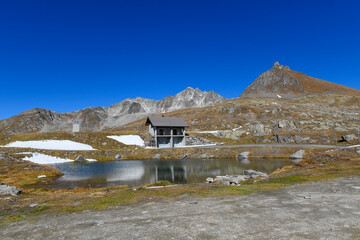 high mountain lake in September with mountains and blue sky