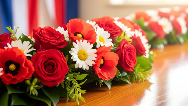 Patriotic floral arrangement showcasing red roses, poppies and white daisies set against an american flag backdrop - Powered by Adobe