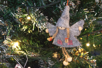 A whimsical Christmas ornament shaped like a small angel or fairy
