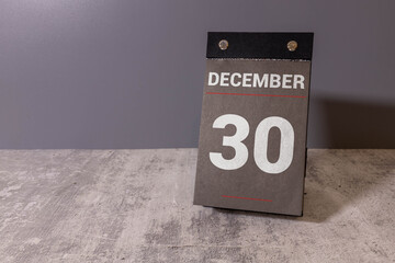 December 30 vintage wooden block calendar bokeh lights background.