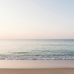 Obraz premium Wide panoramic view of a tranquil ocean shoreline featuring soft sand, gentle waves, and a serene horizon line under a pale sky, outdoor, shoreline, backdrop