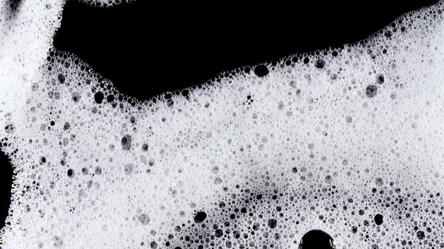 Texture of white soap foam with bubbles abstract background. Soap sud macro structure. Bathtup Soap Foam. Natural White Shampoo Bubbles Motion. High quality 4k footage