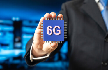A businessman holds a 6G electronic chip. A new standard in communications technology. Network modernization. Technology news, telecom innovation, and the evolution of high-speed connectivity.
