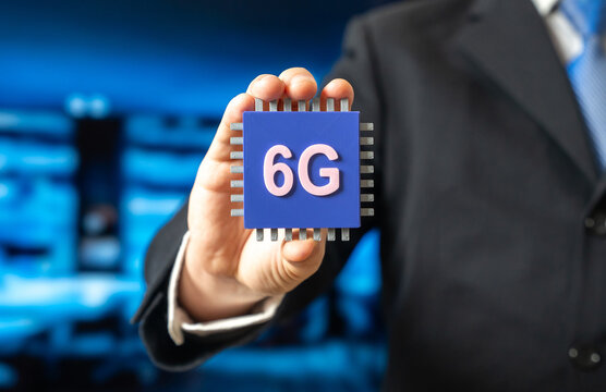 A businessman holds a 6G electronic chip. A new standard in communications technology. Network modernization. Technology news, telecom innovation, and the evolution of high-speed connectivity.