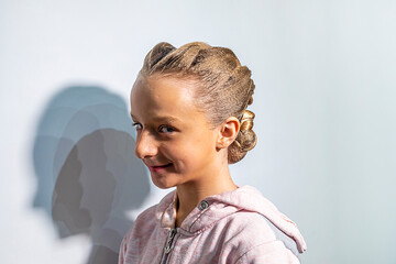 Happy girl with a ballroom dancing hairstyle against a light