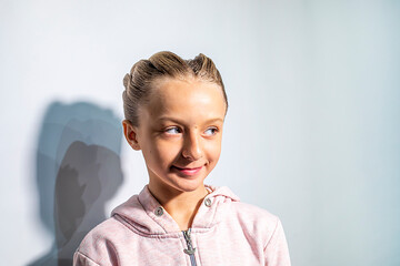 Happy girl with a ballroom dancing hairstyle against a light