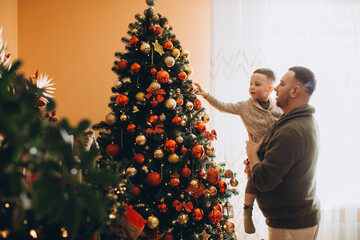 Father and son decorating christmas tree