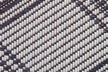 Fototapeta premium Handwoven fabric pattern with dark and white threads creating artisan textile design. Natural background, texture, copy space. Traditional weaving, craft handmade fabric