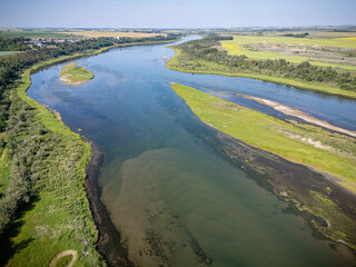 River with a green bank and a brown bank