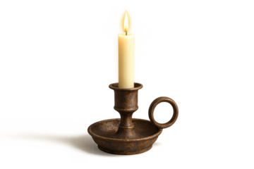 Lit candle in an antique bronze candlestick isolated on transparent background