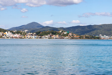  Buildings in Bombinhas beach with mountains and forest in background
