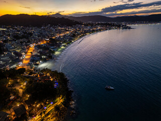 Aerial view of Bombinhas beach night lights at sunset