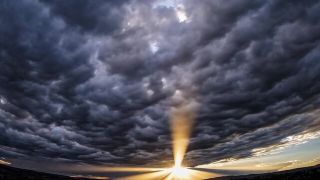 Dark, swirling clouds gather ominously in the sky as golden rays of sunlight break through, creating a dramatic contrast. The scene captures the raw beauty of nature's changing moo