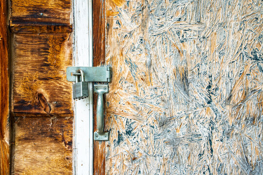 Rusty lock on a wooden door