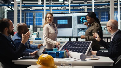 Investors meet to talk about automation strategies for solar panel production scaling. Shareholders in photovoltaics factory doing financial investments in green energy manufacturing sector, camera A
